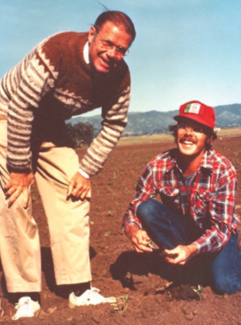 Craig And Robert McNamara Kneeling on a Farm